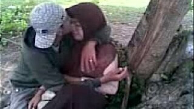 Schoolgirls in hijabs make out cool in the park.