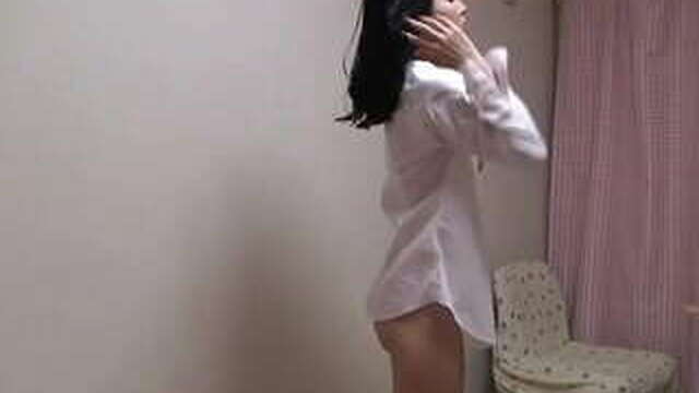 A naked Japanese girl wears a school uniform in a miniskirt