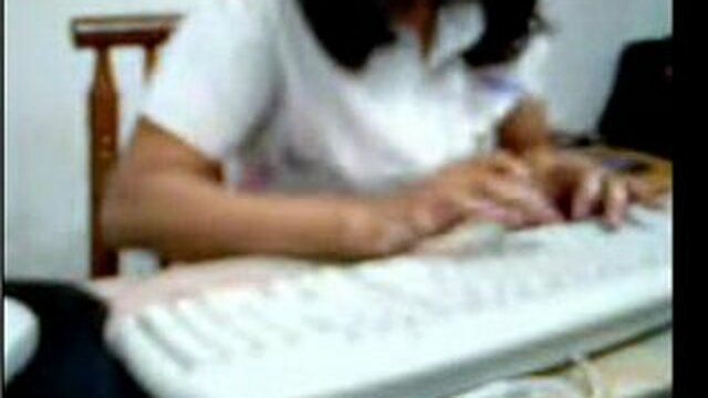 An Indian woman in an office cubicle