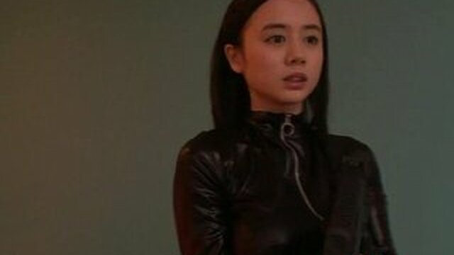 Costumed Asian mommy in a jumpsuit with cum on her face